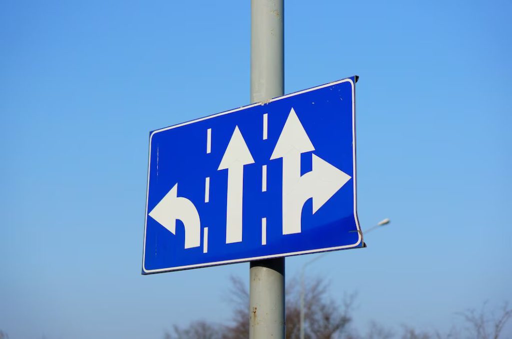 low-angle-shot-blue-directions-sign-with-white-arrows_181624-20064-1024x679