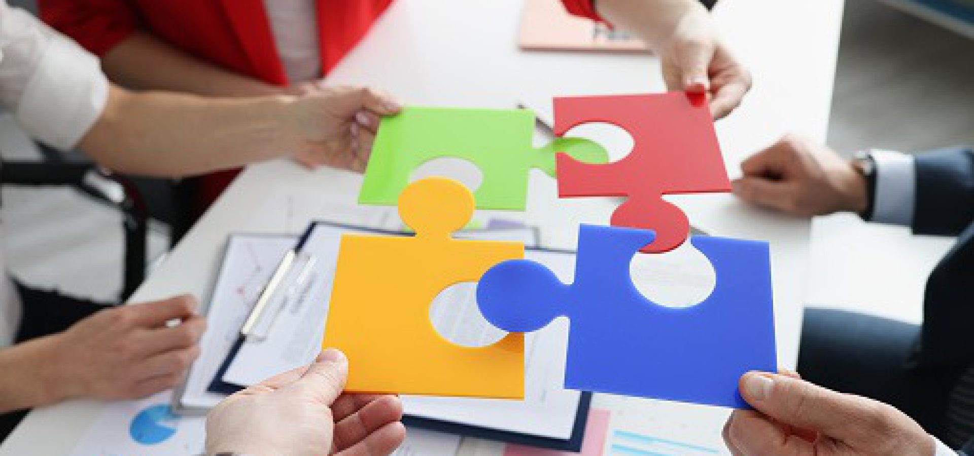 Business people put multi-colored puzzles into one. New ideas for business development concept