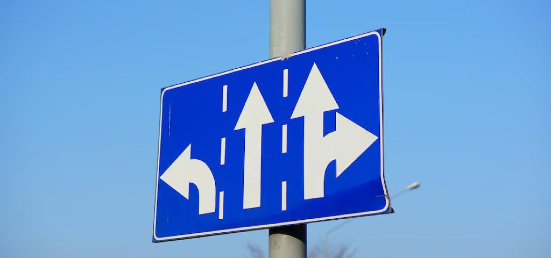 low-angle-shot-blue-directions-sign-with-white-arrows_181624-20064-1024x679